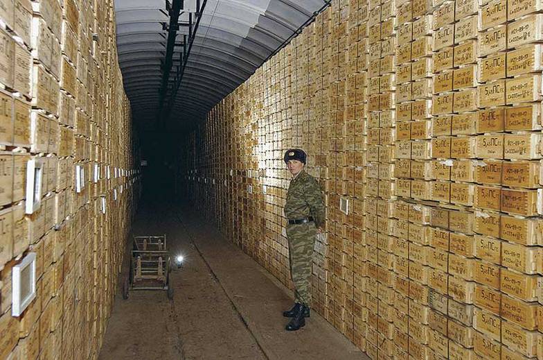 ИТАР-ТАСС/ ВАДИМ ДЕНИСОВ Военные склады в селе Колбасна были созданы в 1940-х годах. Основную часть боеприпасов сюда завезли после вывода советских войск из стран Варшавского договора. В 2000 году объемы вооружений и боеприпасов оценивались в 42 тыс. тонн. Впоследствии половина была утилизирована, другая половина большей частью просрочена и распродана